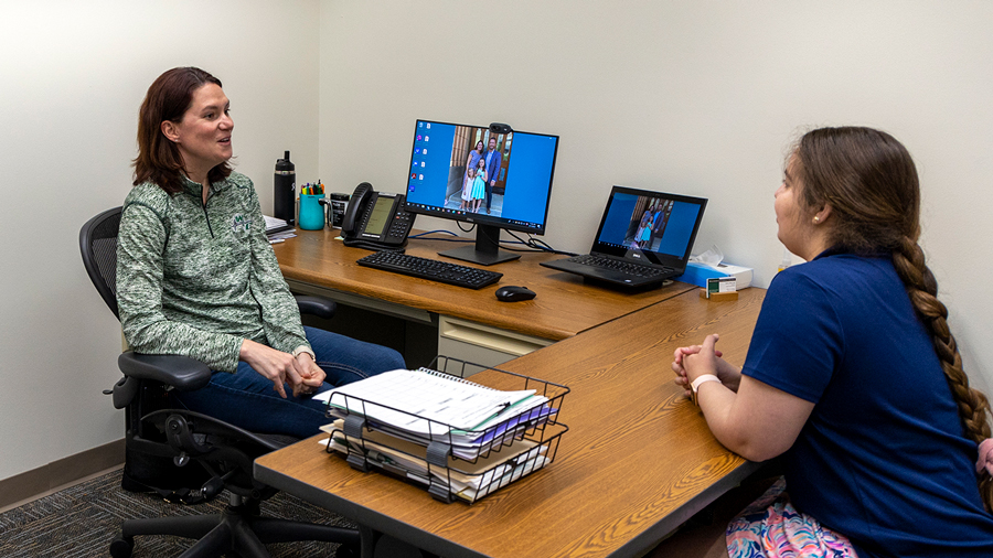 Advisor meeting with a student in an office