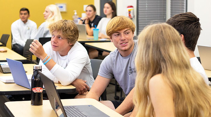Students conversing in business class