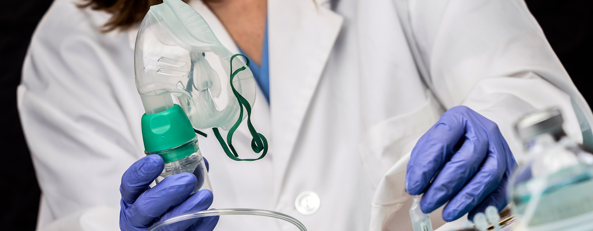 Respiratory therapist holding oxygen mask