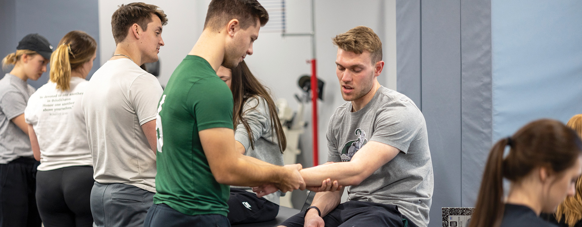 Students using equipment in sport and exercise science lab