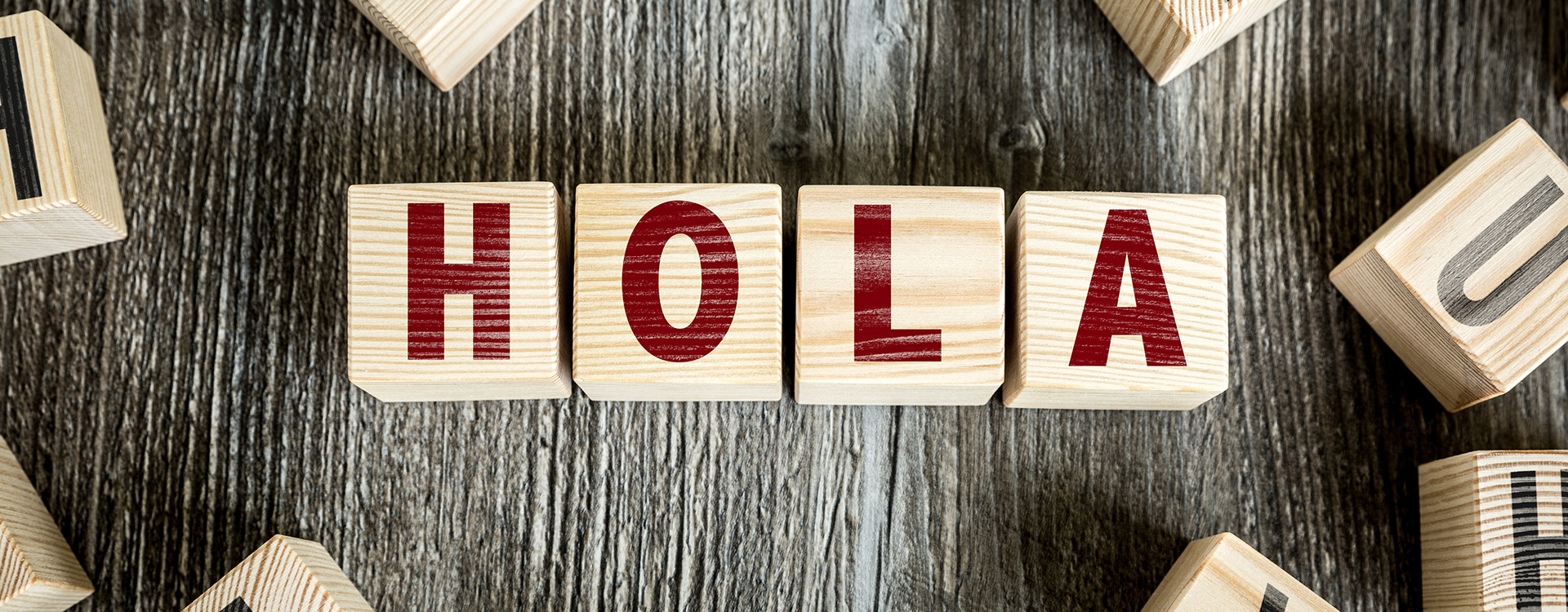 Spanish word for hello HOLA spelled with toy blocks