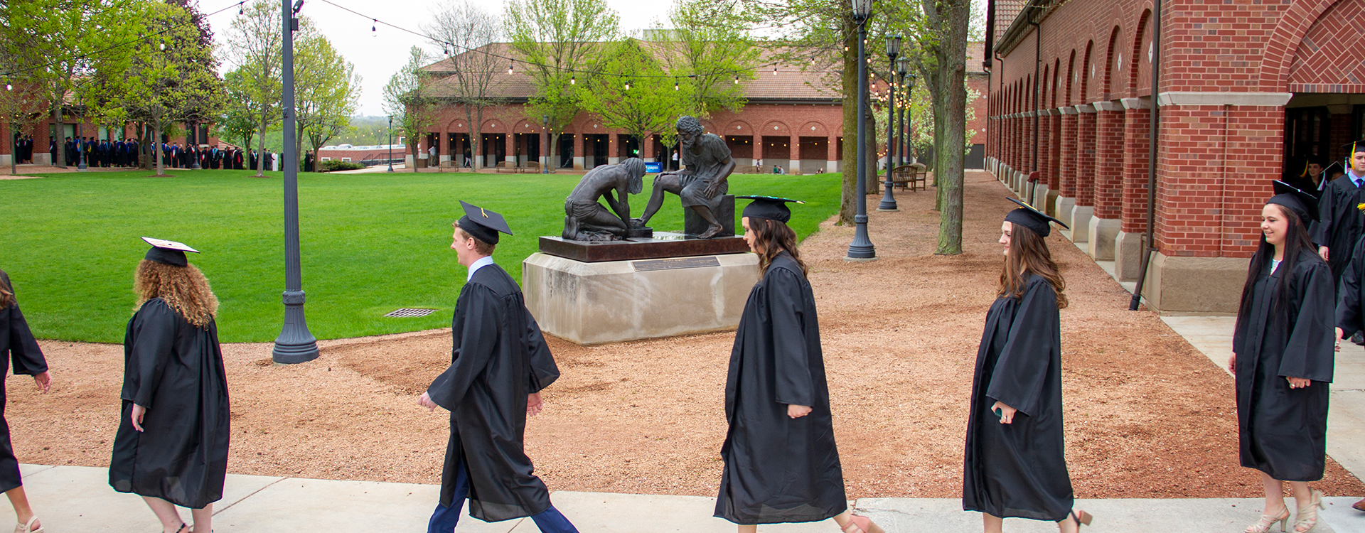 Students processing outdoors at commencement