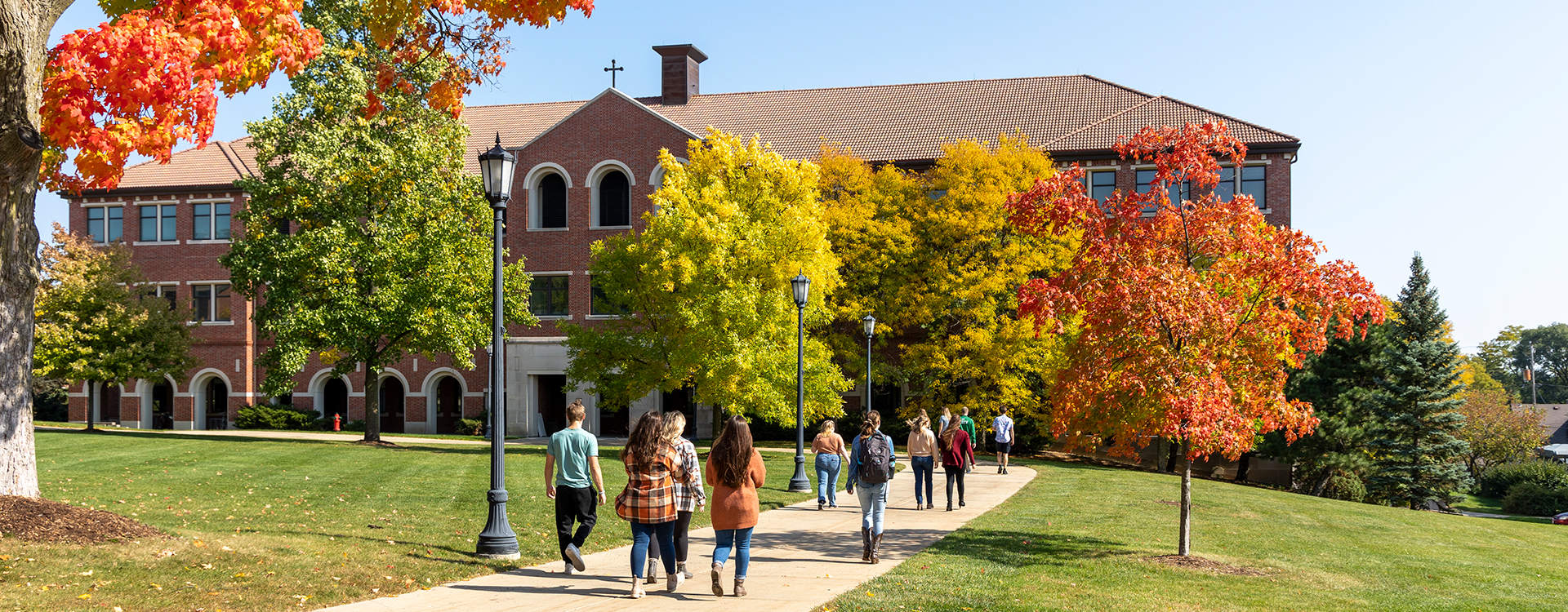 Student walking to Generac Hall during autumn