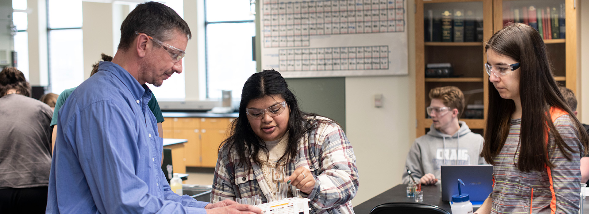 Professor with students in a chemistry lab