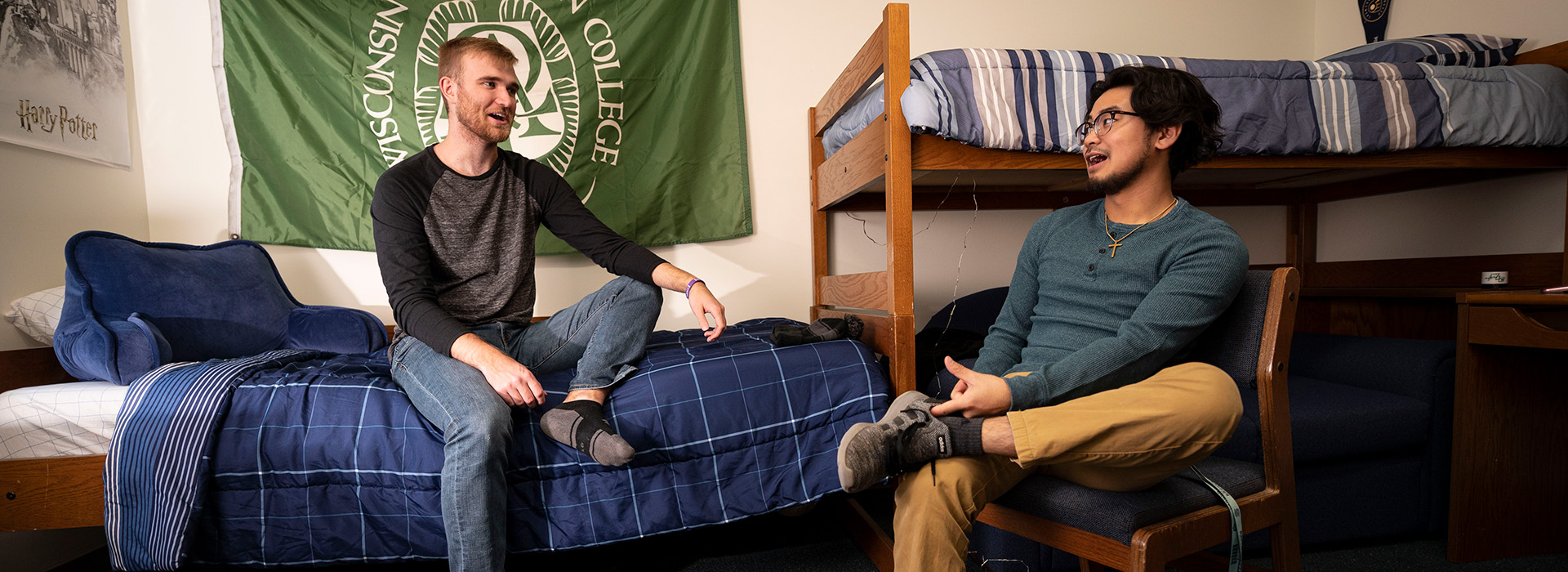 Two male students hanging out in a residence hall room
