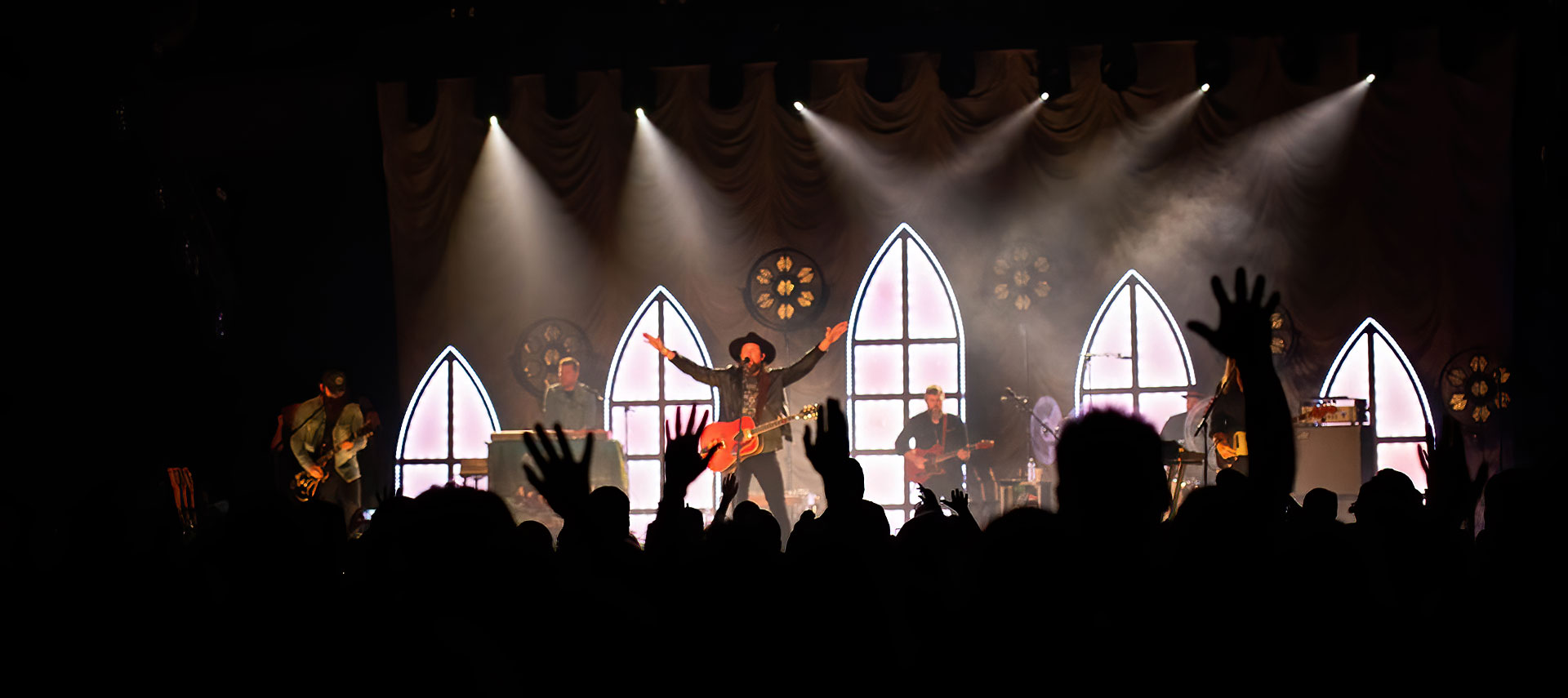 Crowd of people and dramatic stage lights at Christian concert event on WLC campus