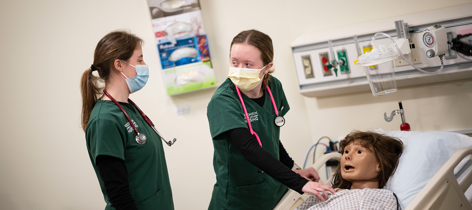 Nursing students in lab with simulator