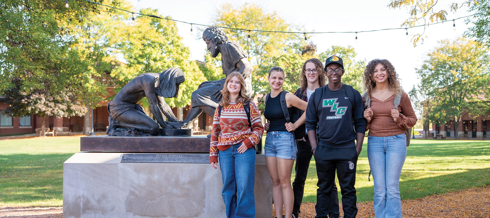 Students by Divine Servant statue