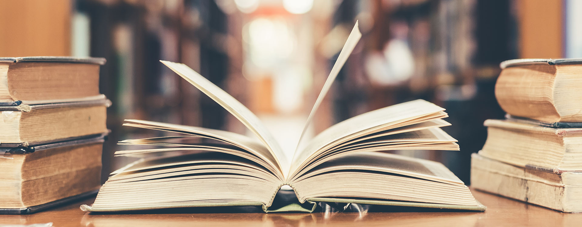 Open old book on a table in a library