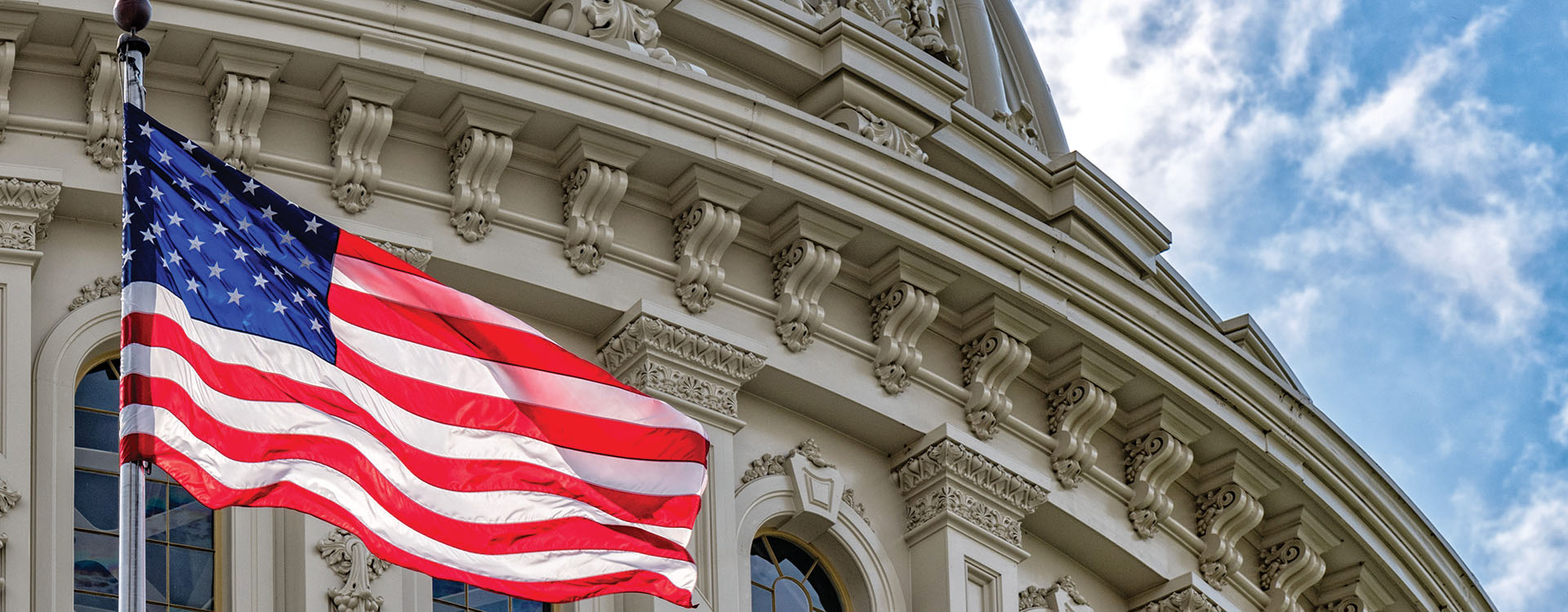 American flag flying in front of a government building