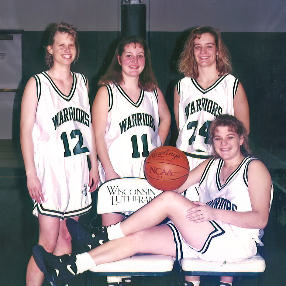 Four women's basketball players posing for photo