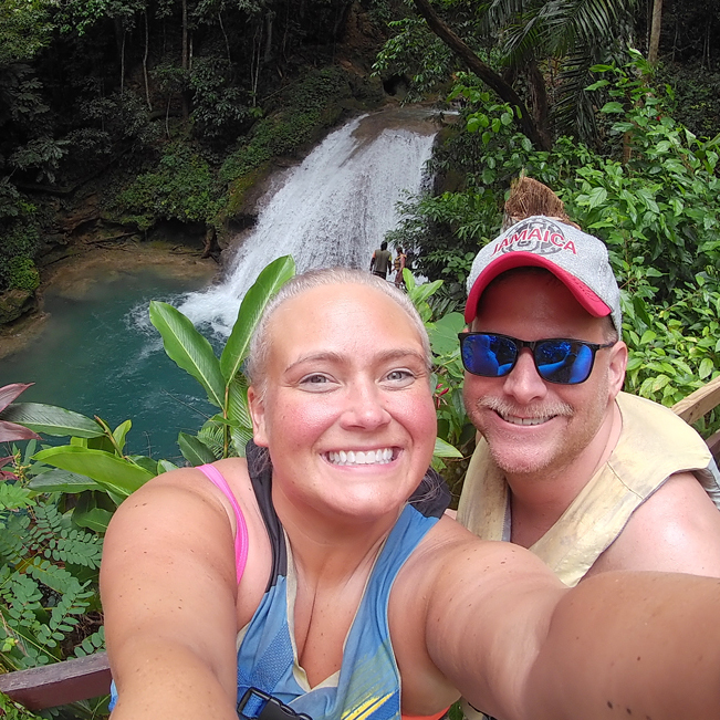 Featured alum and her husband by a waterfall