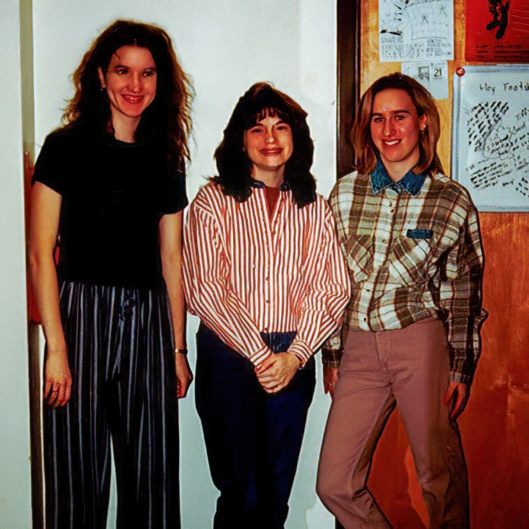 three students standing by door