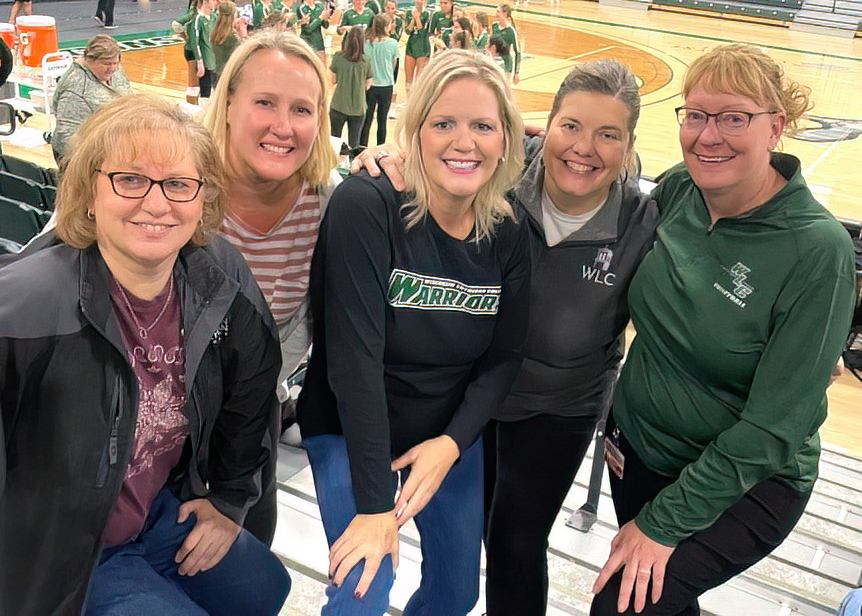 alumni in the bleachers at volleyball match